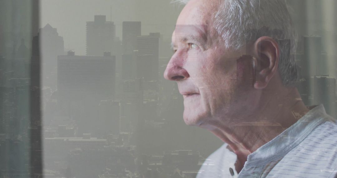 Elderly man gazing through window with city skyline double exposure, contemplative portrait