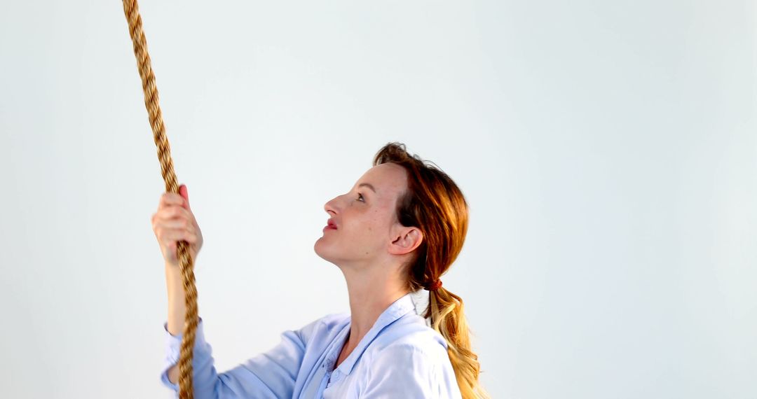 Woman Holding Rope Looking Up with Determination - Free Images, Stock Photos and Pictures on Pikwizard.com