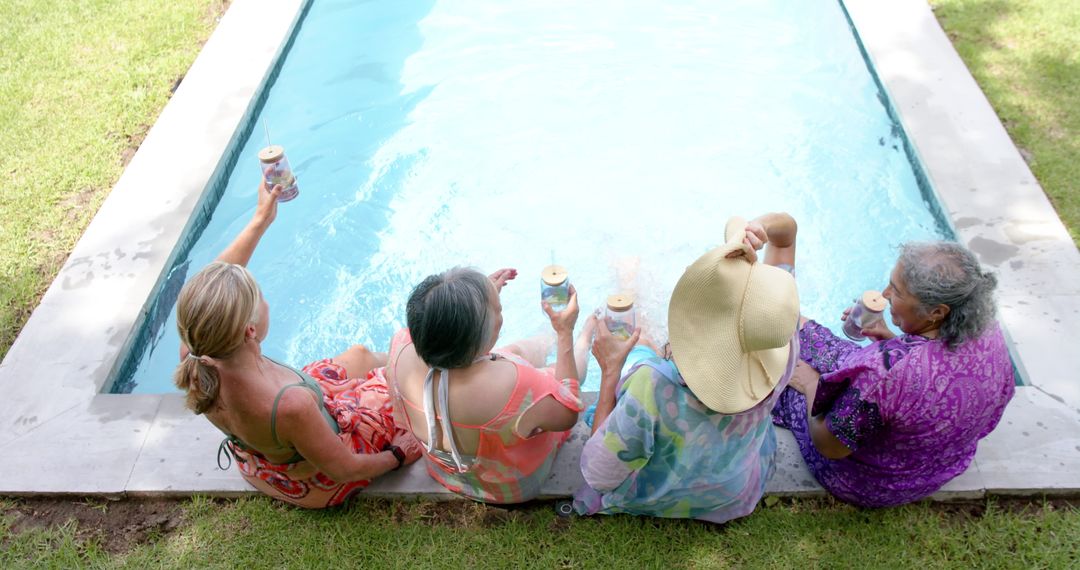 Senior Women Relaxing by Poolside with Drinks