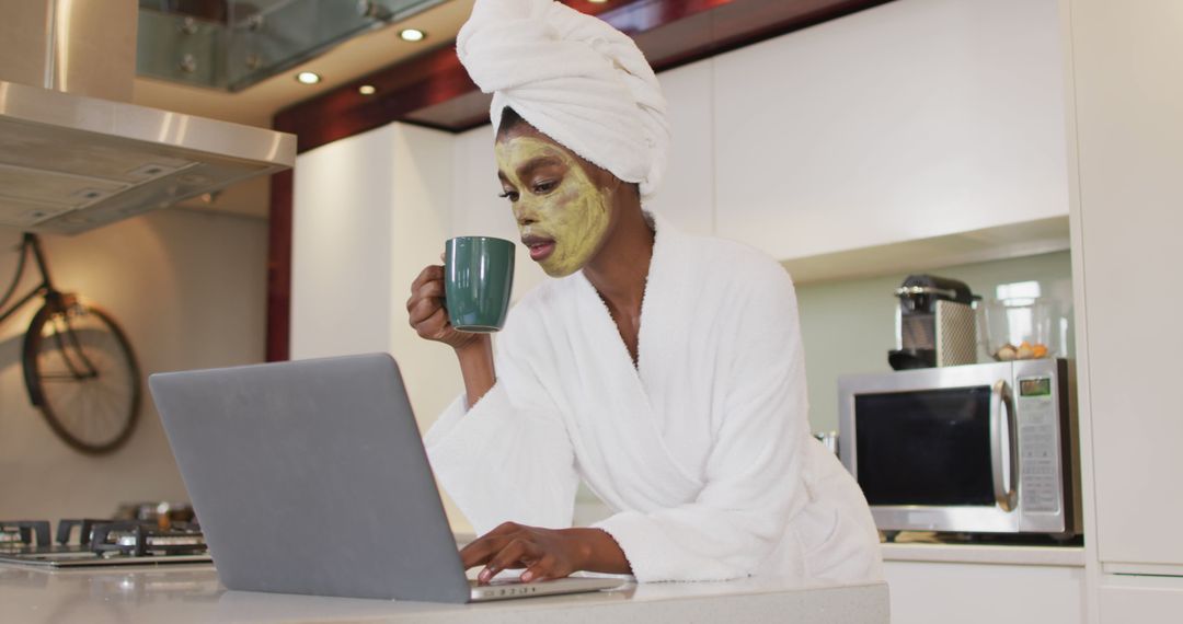 An African American woman enjoys coffee and laptop time during a home spa session. - Free Images, Stock Photos and Pictures on Pikwizard.com