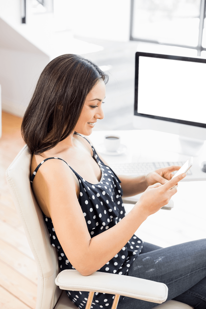 Woman in Polka Dots Checking Mobile in Transparent Office
