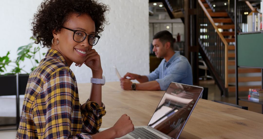 Confident Businesswoman Working on Laptop in Modern Office Environment