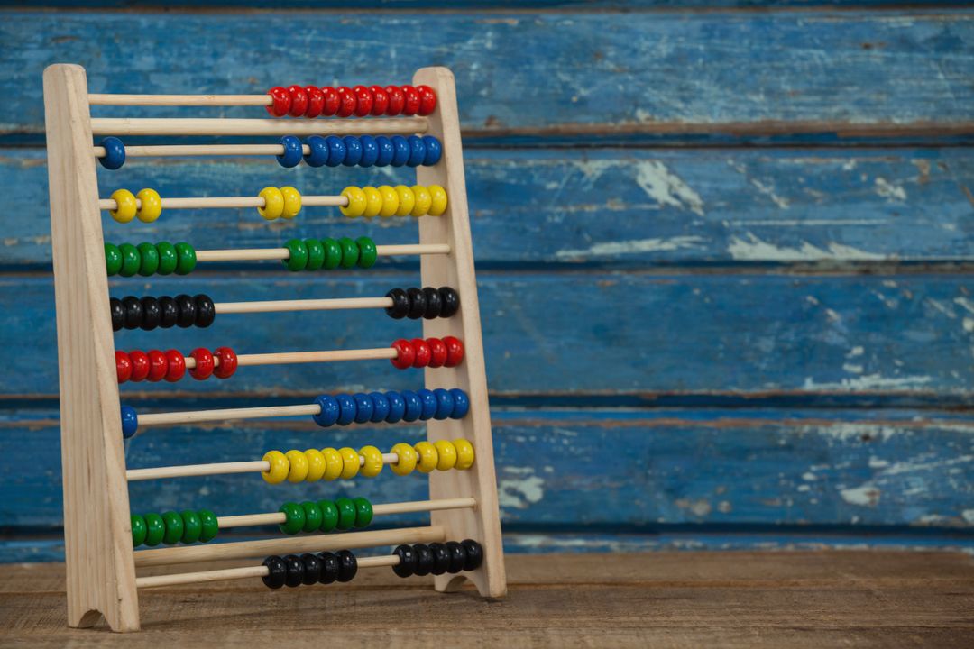 Colorful Abacus on Wooden Table with Blue Background - Free Images, Stock Photos and Pictures on Pikwizard.com