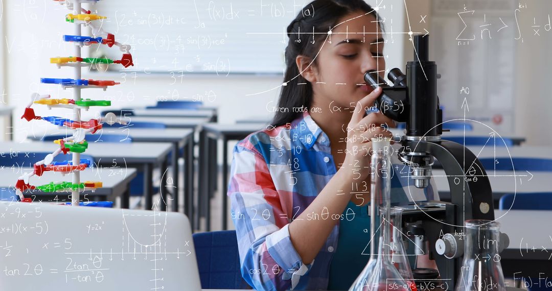 Asian Student Using Microscope for Scientific Experiment in Classroom