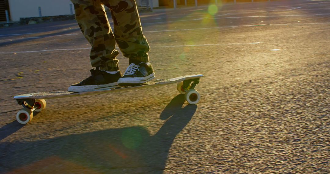 Skateboarder in sunset with camouflage pants - Free Images, Stock Photos and Pictures on Pikwizard.com