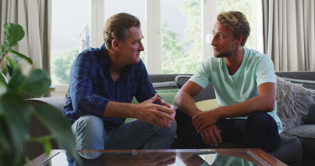 Father and Grown Son Having a Serious Conversation at Home - Free Images, Stock Photos and Pictures on Pikwizard.com