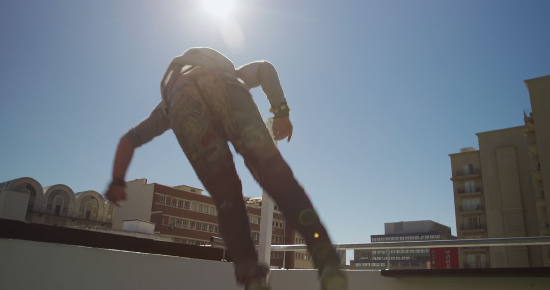 Person Performing Freerunning Stunts on Urban Rooftop - Free Images, Stock Photos and Pictures on Pikwizard.com