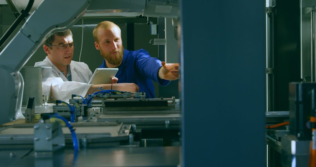 Engineers Working on Industrial Machinery in High-Tech Facility - Free Images, Stock Photos and Pictures on Pikwizard.com