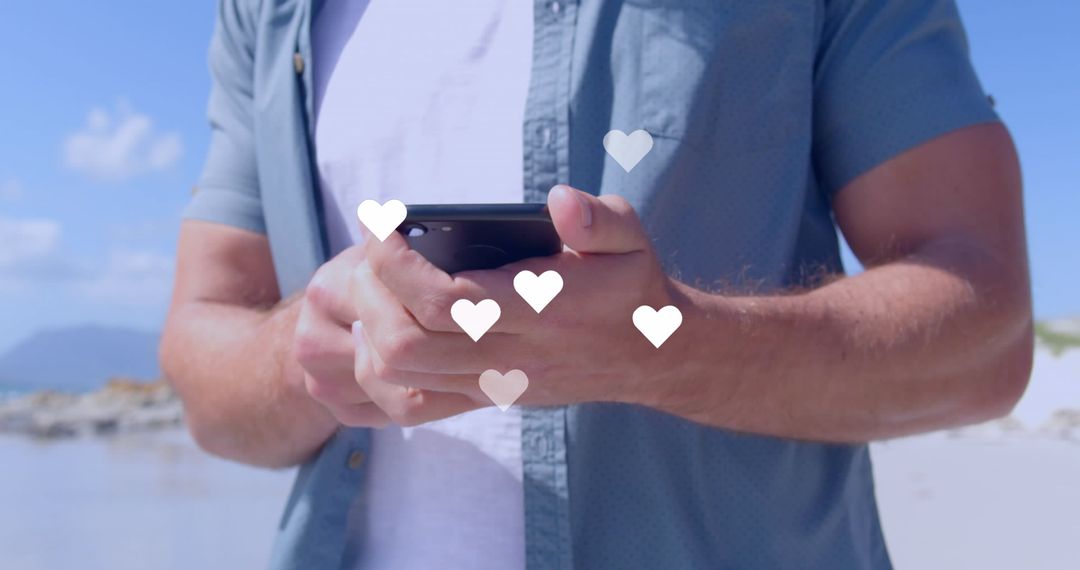 Close-Up of Man Using Smartphone with Heart Icons on Beach