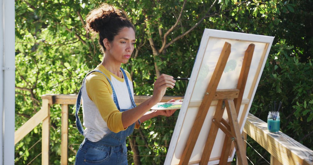 Focused Woman Painting Outdoors on Easel - Free Images, Stock Photos and Pictures on Pikwizard.com