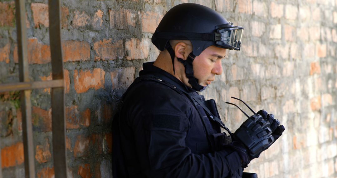 Swat Team Officer Resting Against Brick Wall - Free Images, Stock Photos and Pictures on Pikwizard.com