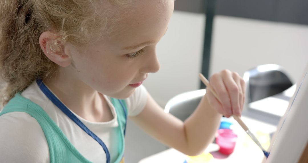 Young Girl Embracing Artistic Creativity in School Classroom