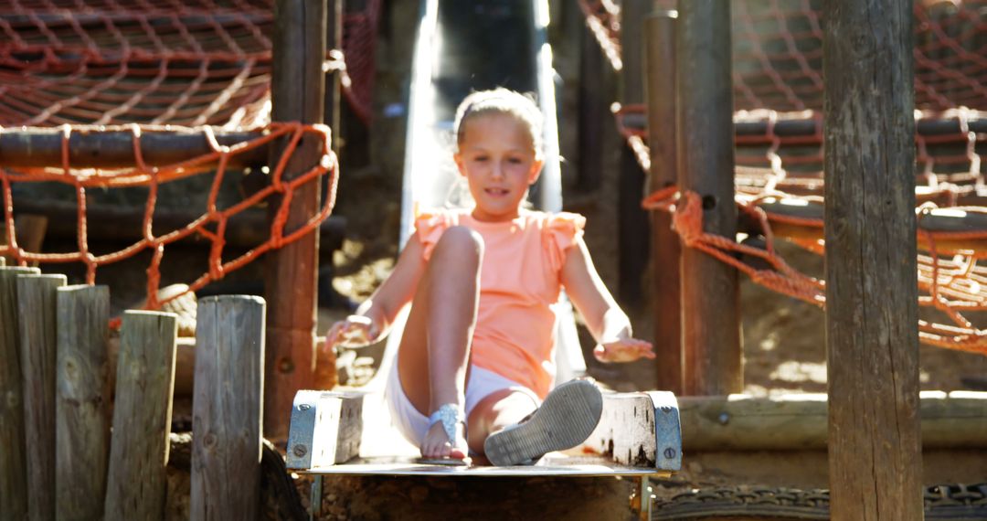 Young Girl Enjoying Playground Slide on a Sunny Day - Free Images, Stock Photos and Pictures on Pikwizard.com