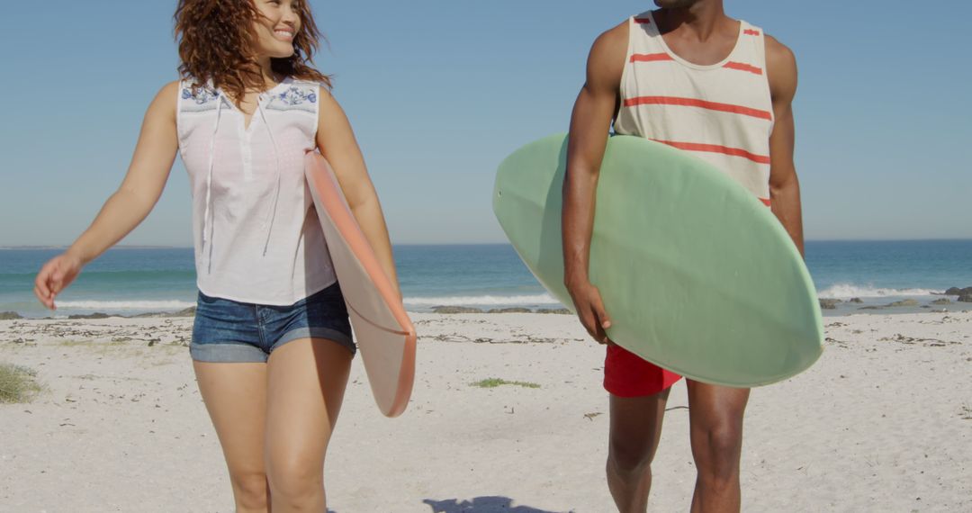 Young Couple Walking on Beach with Surfboards on Sunny Day - Free Images, Stock Photos and Pictures on Pikwizard.com