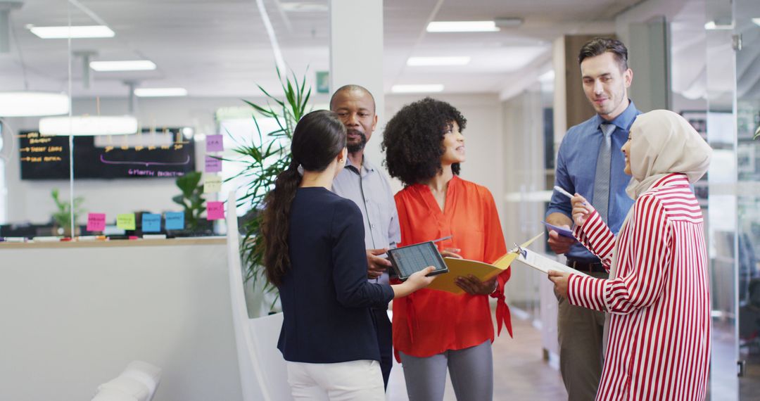 Diverse Team Discussing in Modern Office Environment