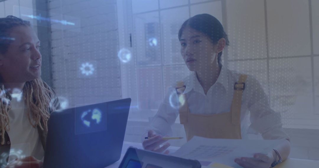 Business Colleagues Analyzing Data with Holographic Technology in Office