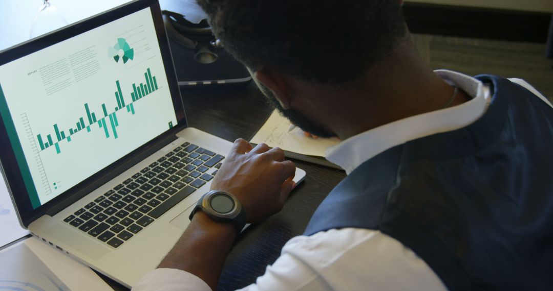 Businessman Analyzing Financial Data on Laptop in Office Setting - Free Images, Stock Photos and Pictures on Pikwizard.com