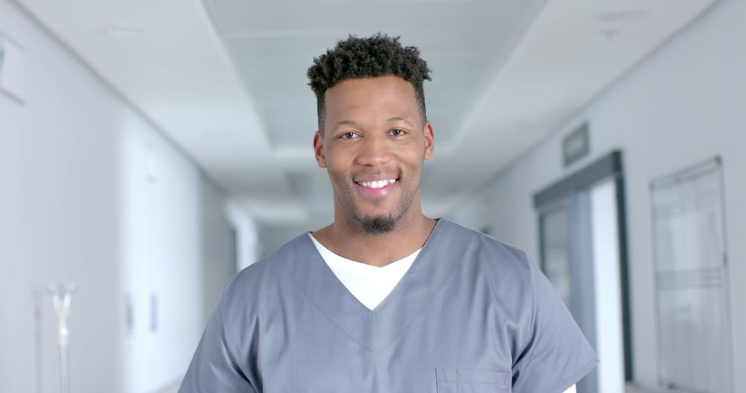 Smiling Male Nurse Standing in Hospital Corridor - Free Images, Stock Photos and Pictures on Pikwizard.com