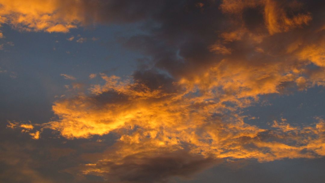 Dramatic Sunset Clouds with Golden and Orange Hues - Free Images, Stock Photos and Pictures on Pikwizard.com