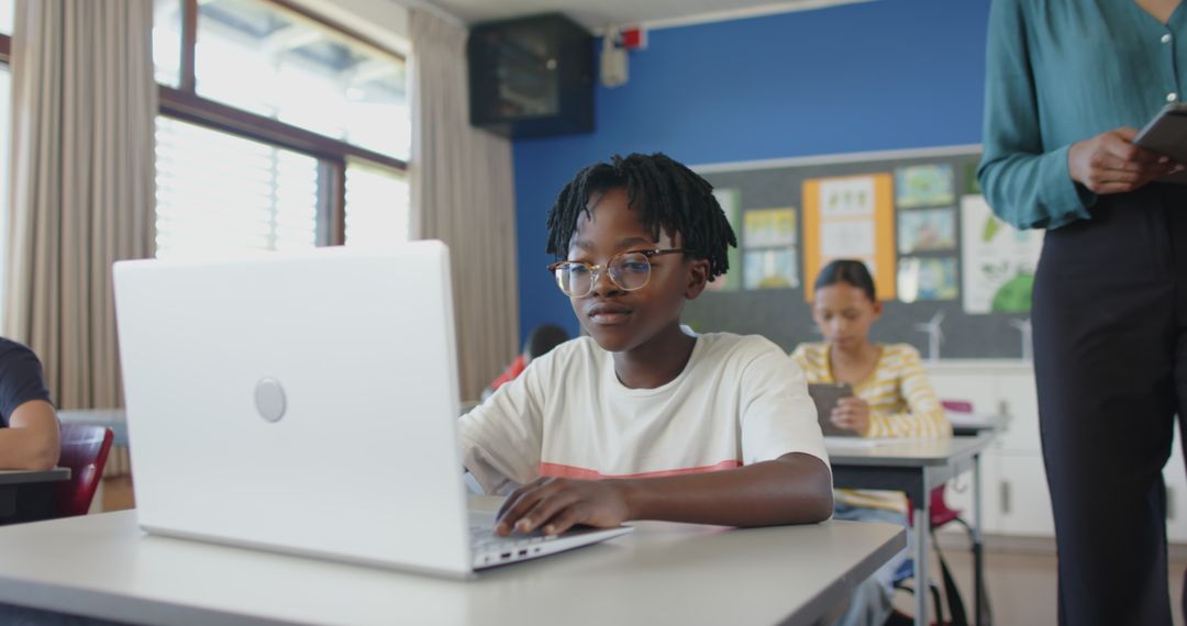 Boy Engaged in Digital Learning on Laptop in Classroom