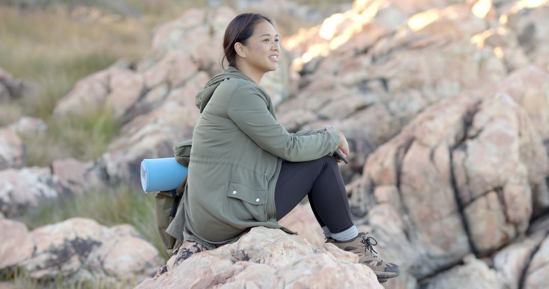 Woman Enjoying Mountain View on Rocky Terrain During Hike