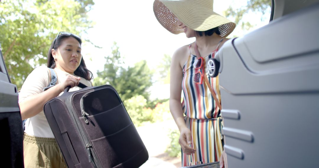 Two Women Loading Luggage into Car for Vacation - Free Images, Stock Photos and Pictures on Pikwizard.com