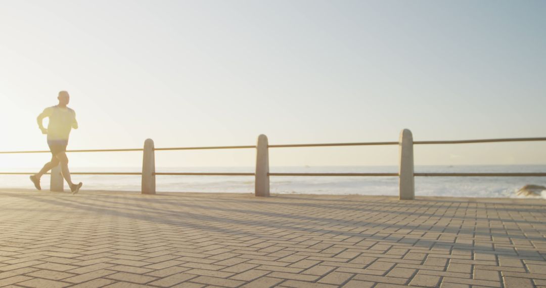 Person Jogging Along Seaside Promenade at Sunset - Free Images, Stock Photos and Pictures on Pikwizard.com