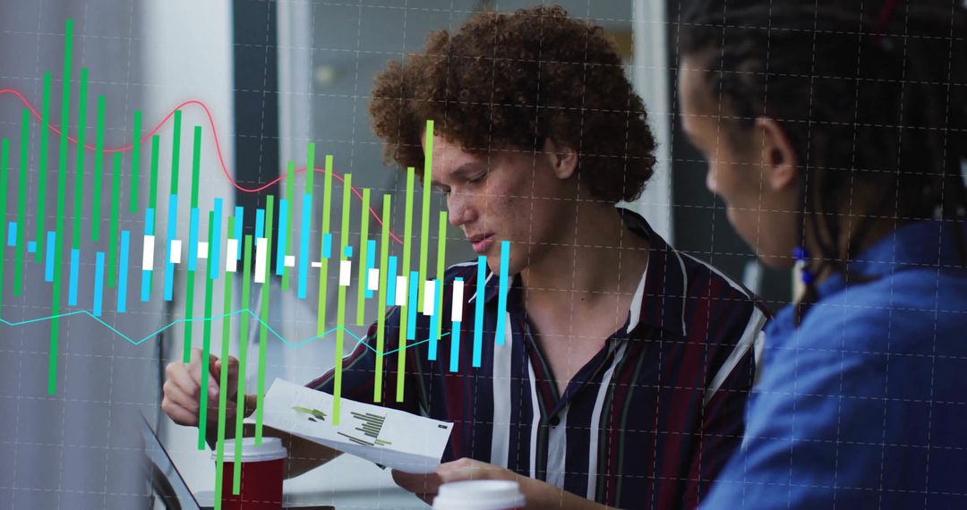 Diverse Team Analyzing Data with Digital Graph Overlay in Office
