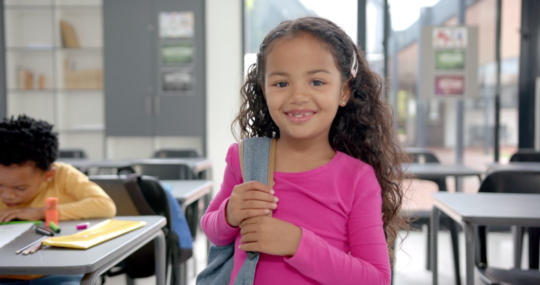 Smiling School Girl with Backpack in Classroom Setting