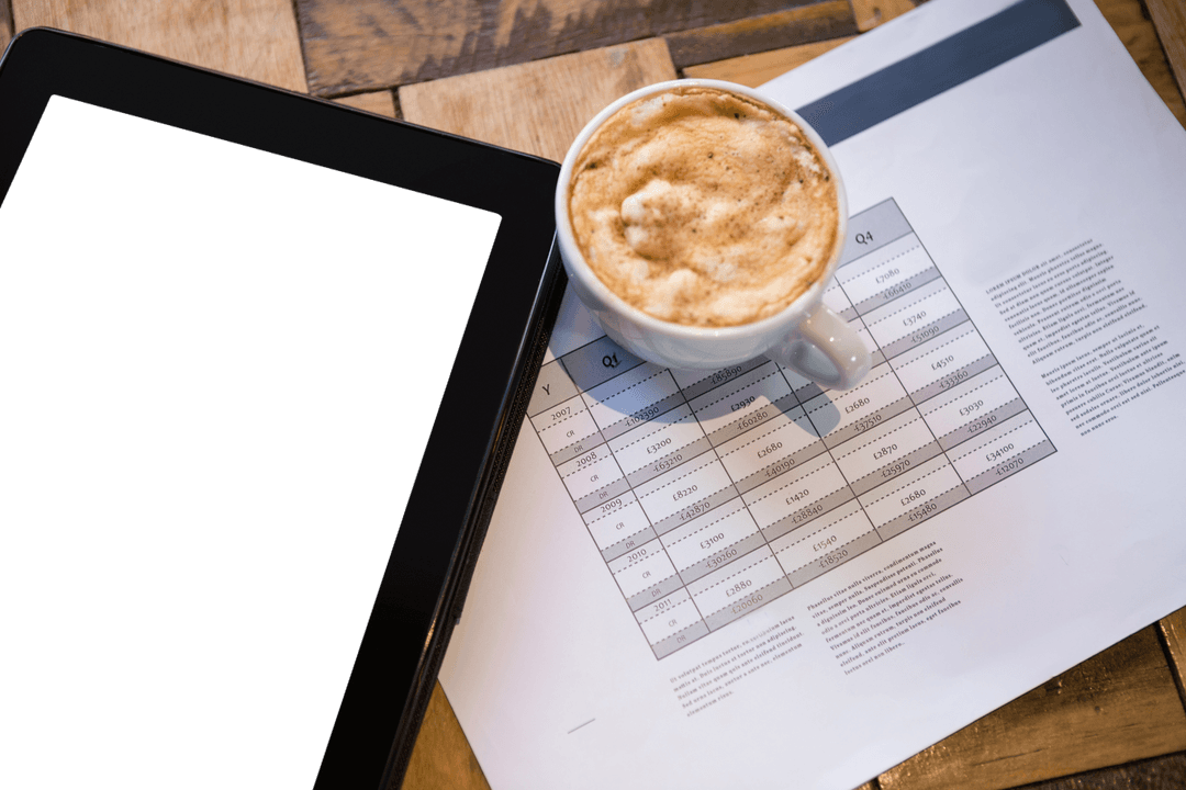 Digital Tablet and Coffee Cup on Document on Wooden Table