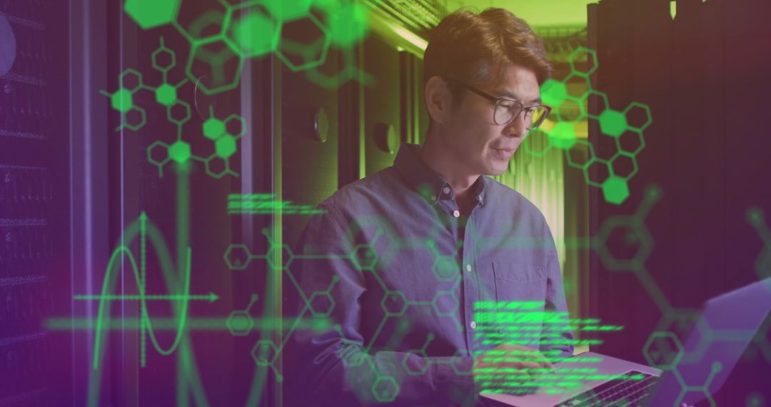 Asian Male Technologist Analyzing Data in High-Tech Server Room