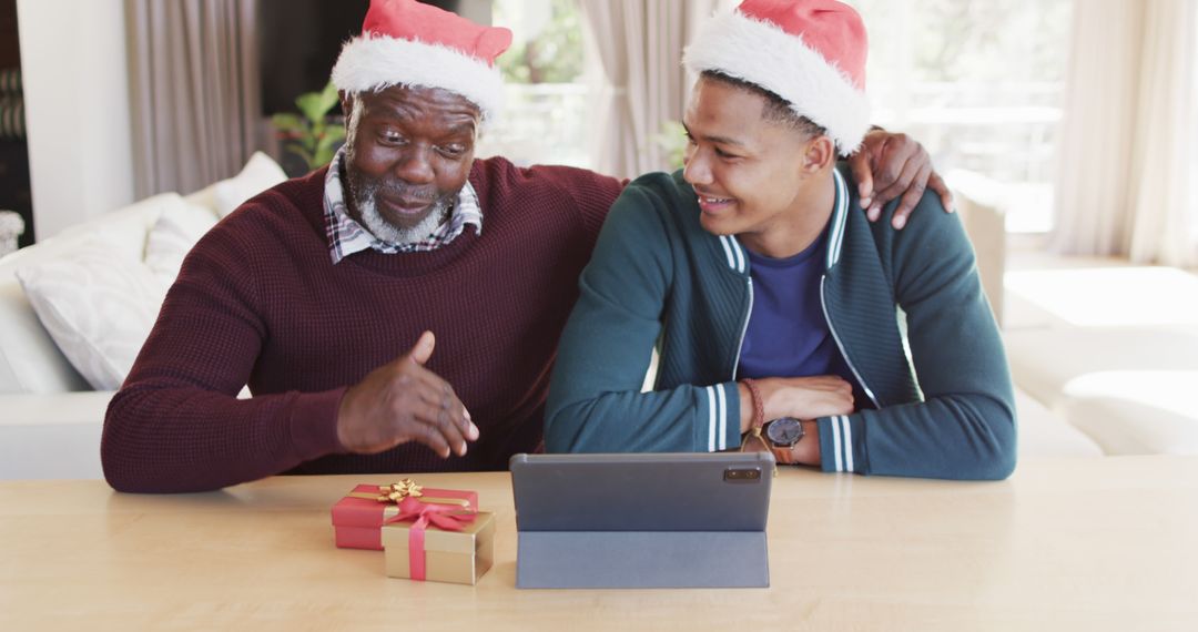 African American Father and Son Celebrating Christmas with Tablet - Free Images, Stock Photos and Pictures on Pikwizard.com