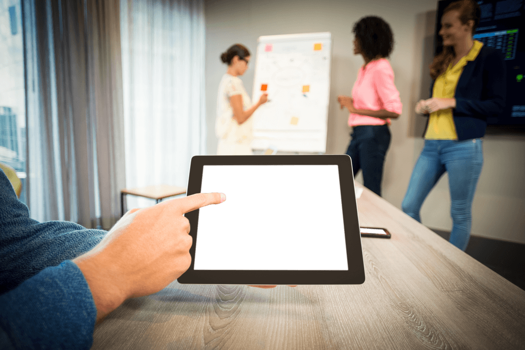 Hand Holding Tablet with Transparent Screen in Office Meeting