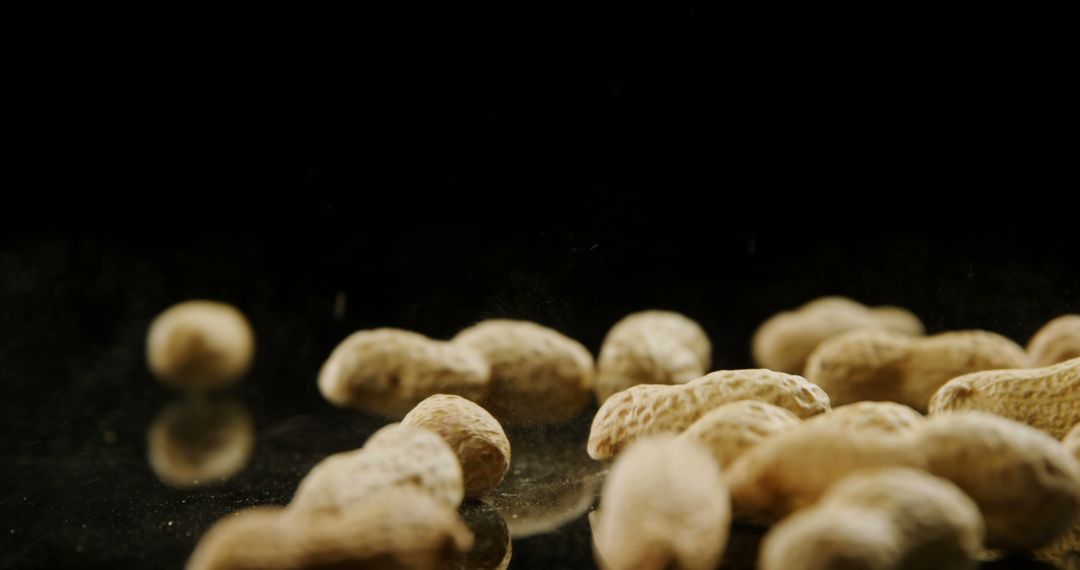 Close-Up of Peanuts on Reflective Surface with Black Background - Free Images, Stock Photos and Pictures on Pikwizard.com