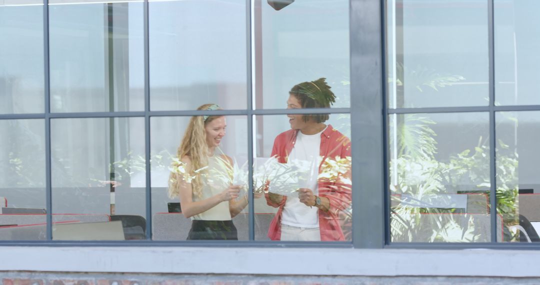 Colleagues Brainstorming in Modern Office Through Window