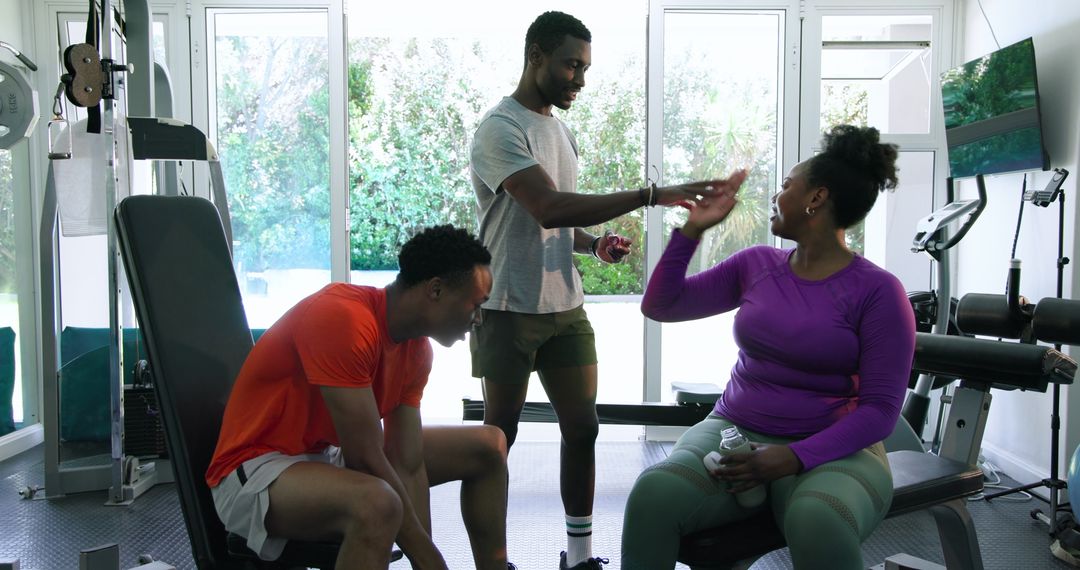 Friends Supporting Each Other While Working Out in Home Gym
