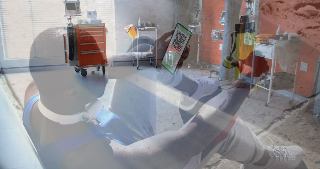 Man Holding Smartphone with QR Code against Hospital Environment
