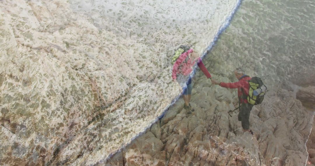 Courageous Couple Navigating Rugged Coastal Terrain Amidst Crashing Waves