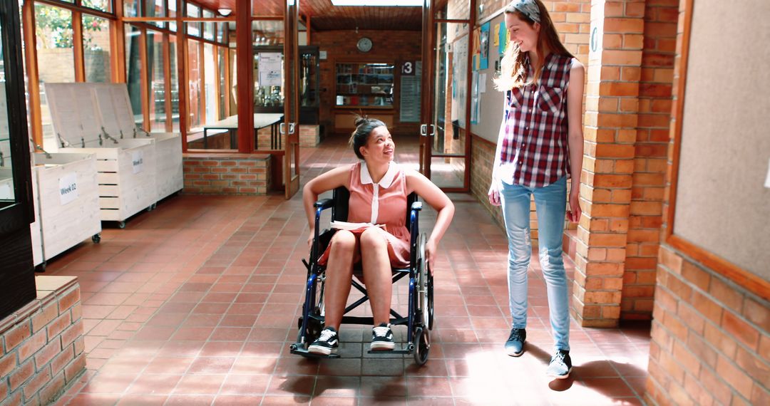 Teen Girl in Wheelchair Interacting with Friend Indoors - Free Images, Stock Photos and Pictures on Pikwizard.com