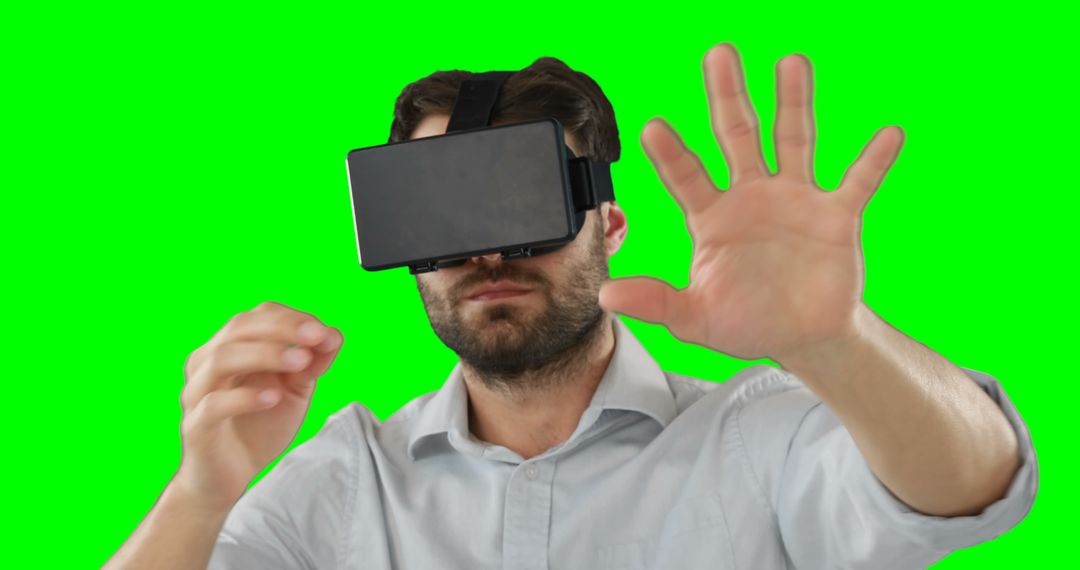 Man immersed in virtual reality with VR headset on green screen background - Free Images, Stock Photos and Pictures on Pikwizard.com