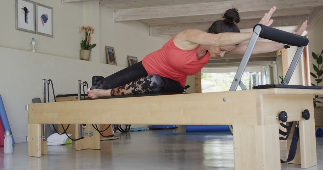 Woman Practicing Pilates on Reformer in Home Studio - Free Images, Stock Photos and Pictures on Pikwizard.com