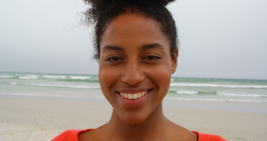 Smiling Young Woman at Beach Facing Camera - Free Images, Stock Photos and Pictures on Pikwizard.com