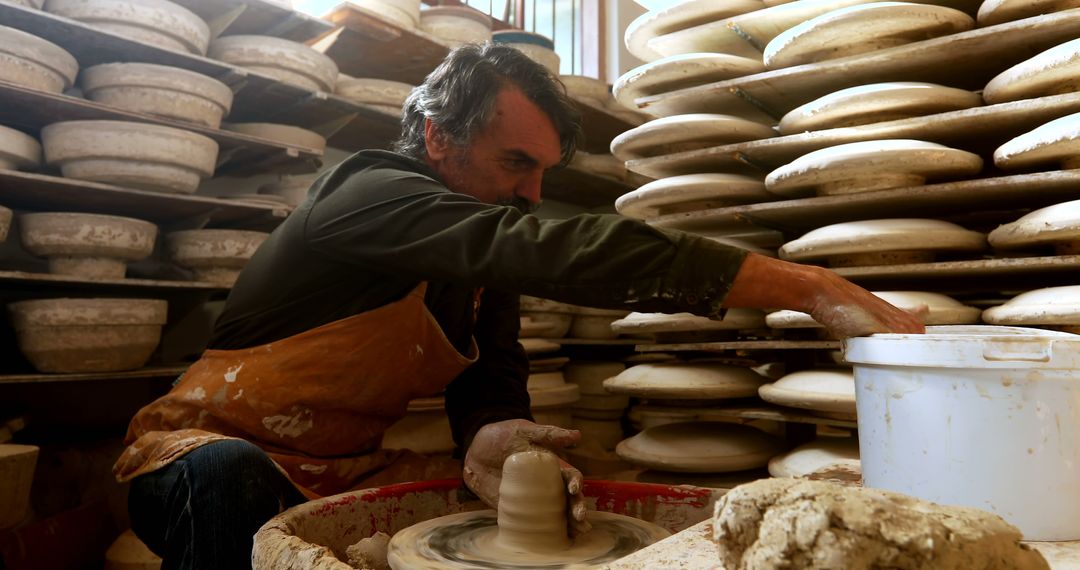 Skilled Potter at Work in Traditional Pottery Studio with Clay Bowls - Free Images, Stock Photos and Pictures on Pikwizard.com