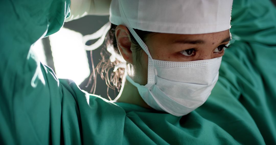 Focused Surgeon Preparing for Surgery in Operating Room - Free Images, Stock Photos and Pictures on Pikwizard.com