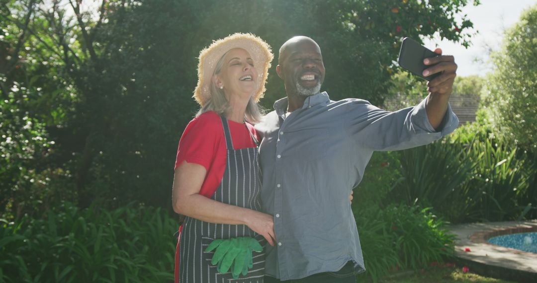 Happy senior diverse couple taking selfie in garden - Free Images, Stock Photos and Pictures on Pikwizard.com