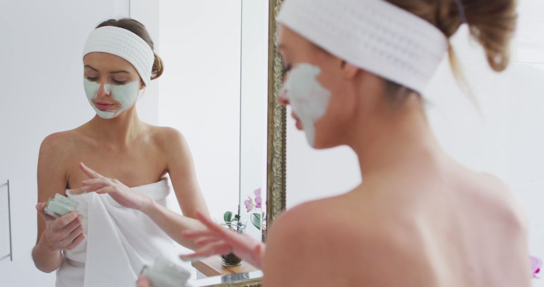 Woman Applying Facial Mask in Modern Bathroom for Self-Care - Free Images, Stock Photos and Pictures on Pikwizard.com