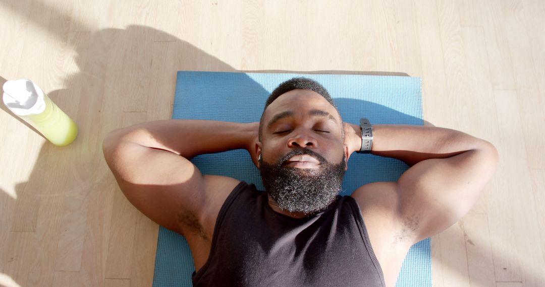 Man Relaxing on Exercise Mat After Workout Session - Free Images, Stock Photos and Pictures on Pikwizard.com