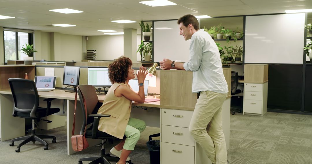 Business Colleagues Conversing Over Coffee in Modern Office Space