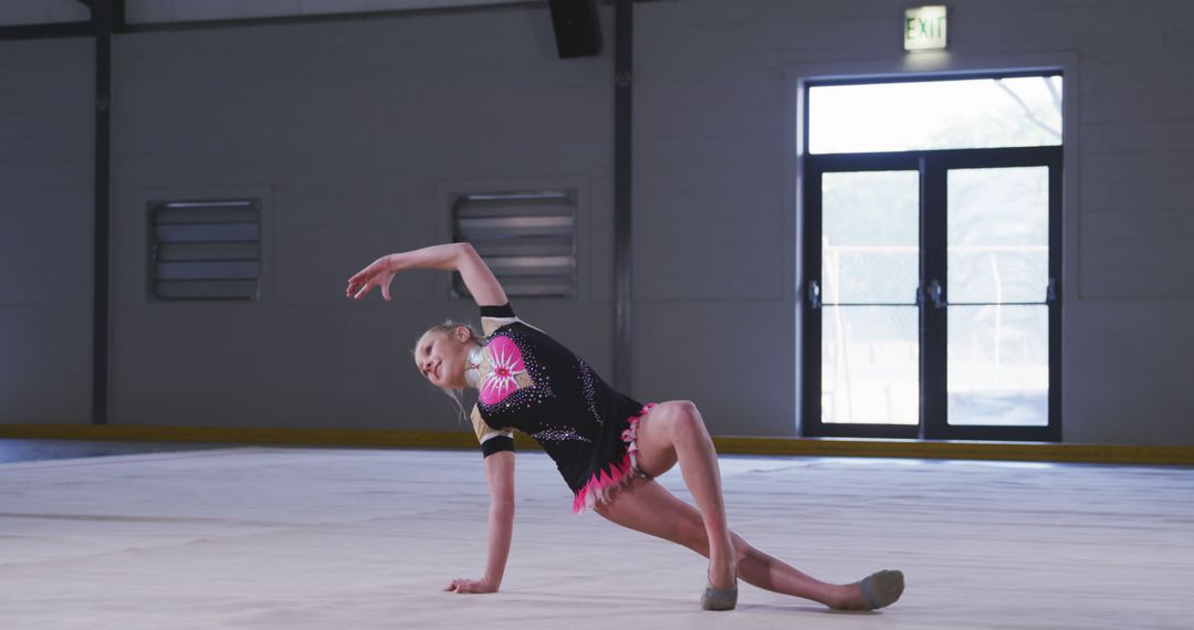 Young Female Rhythmic Gymnast Performing Routine in Gymnasium - Free Images, Stock Photos and Pictures on Pikwizard.com