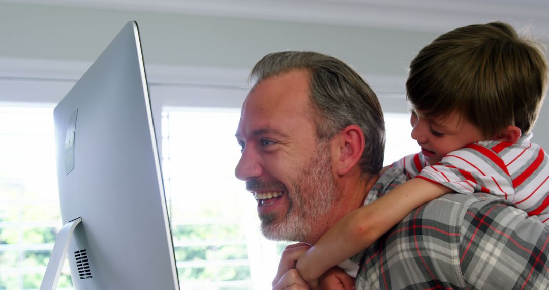 Father and Young Son Bonding at Home While Using Computer - Free Images, Stock Photos and Pictures on Pikwizard.com